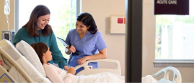 A nurse and a patient in a hospital room with the text ACUTE CARE.