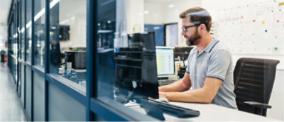A man sitting at a desk with a computer.