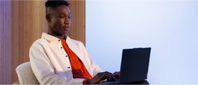 A man in a white shirt using a laptop.