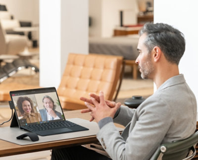 A man talking to a woman on a laptop.