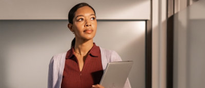 Confident woman holding a tablet.