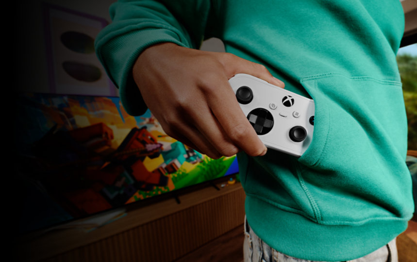 Teenager pulls out the XBOX Nano Controller from their sweatshirt front pocket.