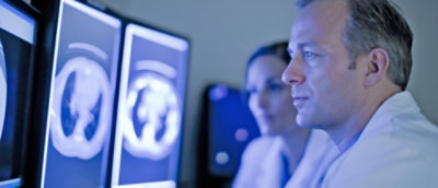 Physicians analyzing medical images together.