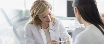 Doctor explaining joint model during visit
