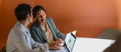 A woman and a man working on a laptop