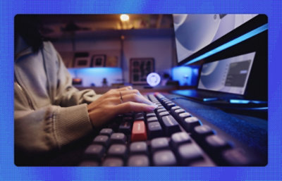 A person's hands typing on keyboard