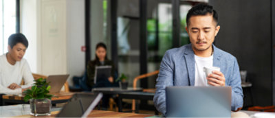A person in a suit using a computer