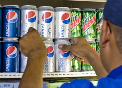 A man holding a can of Pepsi.