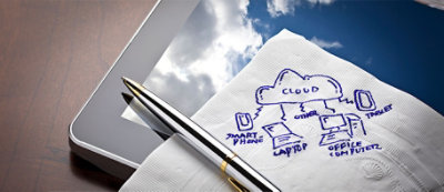 A pen rests on a napkin with a hand-drawn cloud computing diagram.