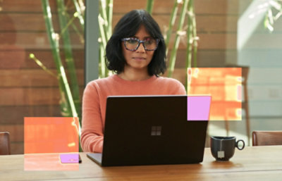 A woman sitting at a desk with a laptop.