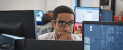 A man looking at the screen