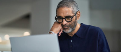 Person using laptop at desk indoors
