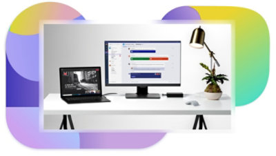 A laptop displaying a presentation being given over a Teams meeting and a desktop monitor displaying a chat in Teams.