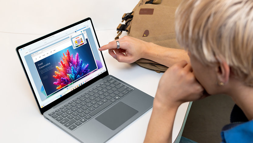 A young man uses Microsoft Office on a Surface Laptop in Ocean.