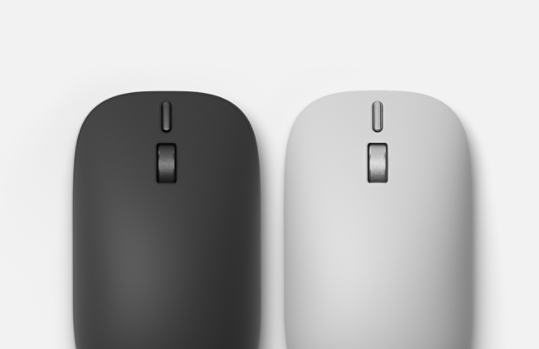 Vue de dessus d’une Souris Surface (2e édition) couleur Platine et d’une Souris Surface (2e édition) couleur Noir côte à côte.