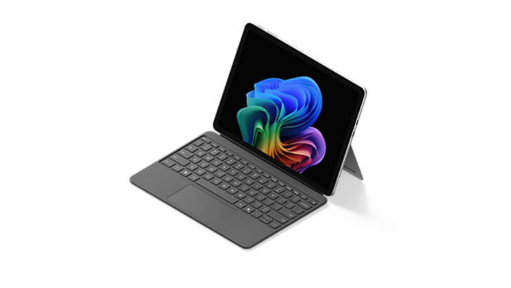 Otwarty komputer Surface Pro z klawiaturą, na którym wyświetlany jest obraz Rainbow Bloom.