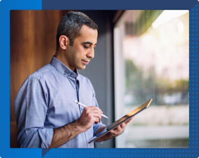 A person holding a tablet and stylus