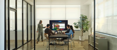 A group of people looking at a screen