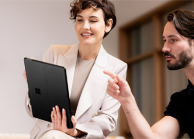 Two people looking at a tablet